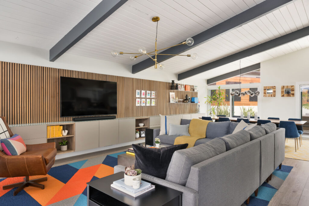 Finished open-concept living room showcasing new hardwood floors and abundant natural light, by ASR Design Studio