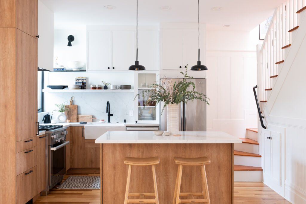 Newly remodeled kitchen with stainless steel appliances and open shelving, designed by ASR Design Studio