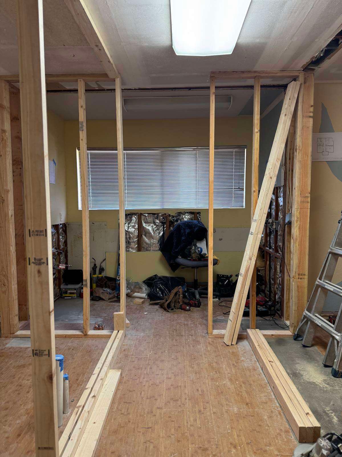Smiles by Pai before: new hallway walls being framed toward the back window