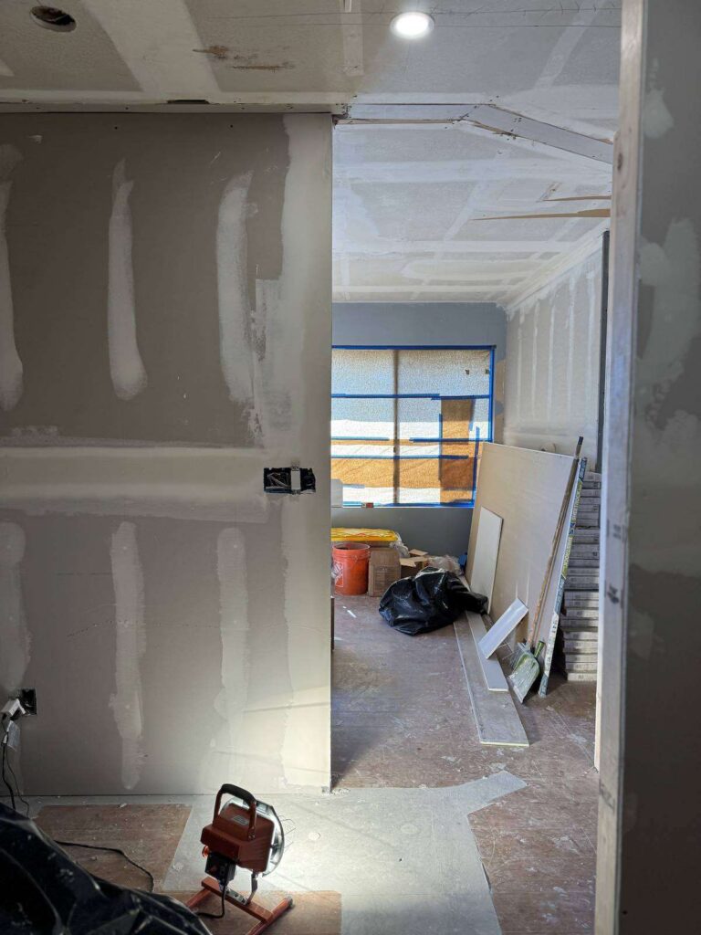 Smiles by Pai during construction: new drywall and hallway taking shape